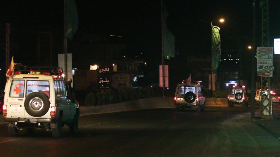 Lebanese Red Cross ambulances carry human remains believed to belong to troops kidnapped by so-called Islamic State militants three years ago, 27 August 2017