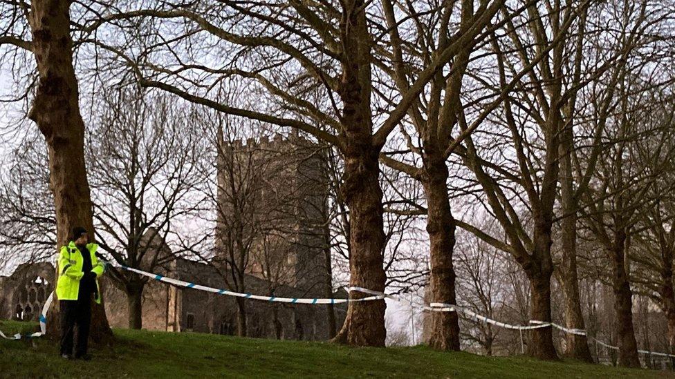 Cordon in place at Castle Park. Police officer and church in shot.