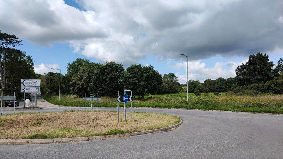 Roundabout picture with a road sign