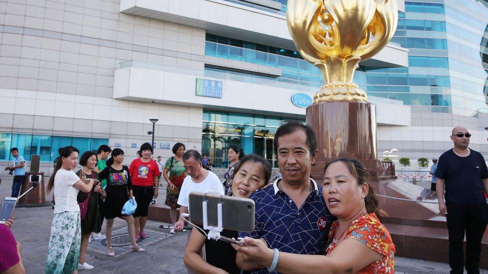 Mainland tourists visit the Golden Bauhinia Square in Wan Chai, 2017