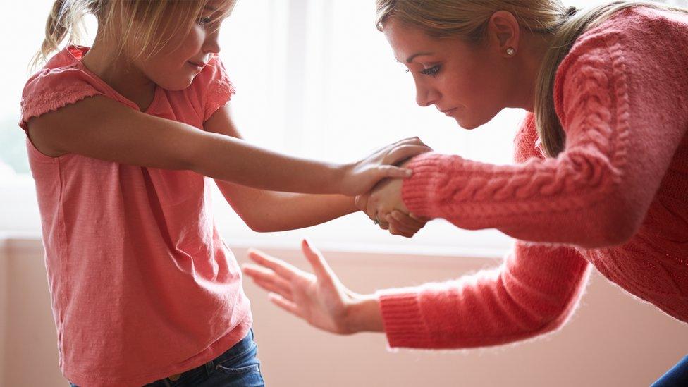 A woman smacking a child