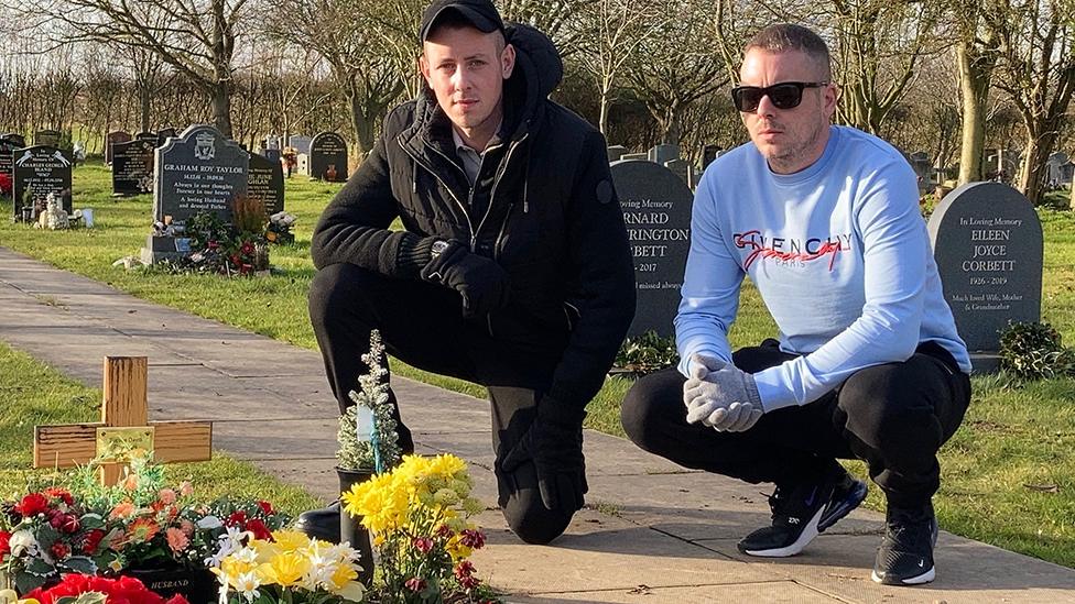 Brothers by their father's grave