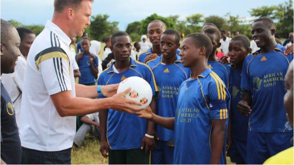 A representative of Sunderland football club with children in Tanzania