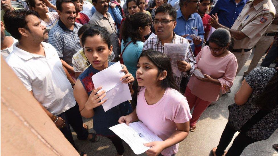 Students check a list before the National Eligibility-Cum-Entrance Test (NEET) exam.