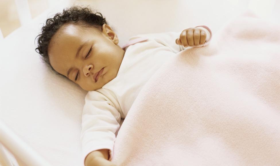 Baby asleep in pink linen