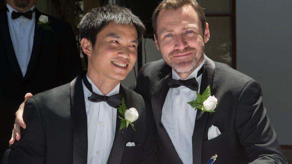 An gay male couple getting married