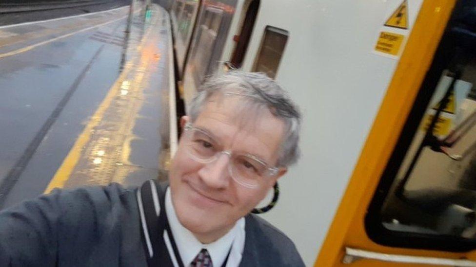 Chris Edwards standing in front of a train on a station platform