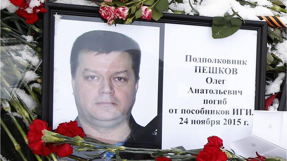 Photo of Russian Lt Col Oleg Peshkov among flowers outside the Russian Defence Ministry building in Moscow, Russia, 26 November 2015