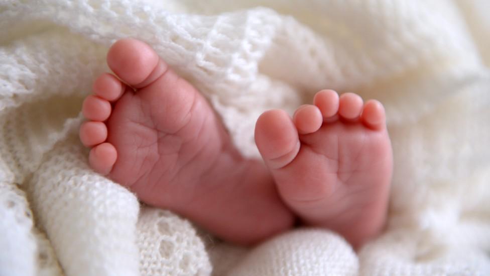 Baby feet wrapped in a blanket