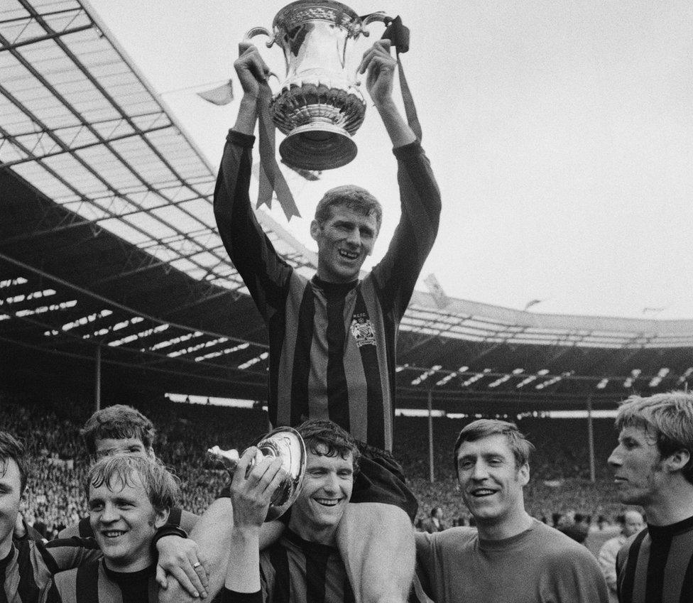 Tony Book lifts the FA Cup. Left to right: Francis Lee, Mike Doyle, Tony Book, Harry Dowd and Colin Bell.