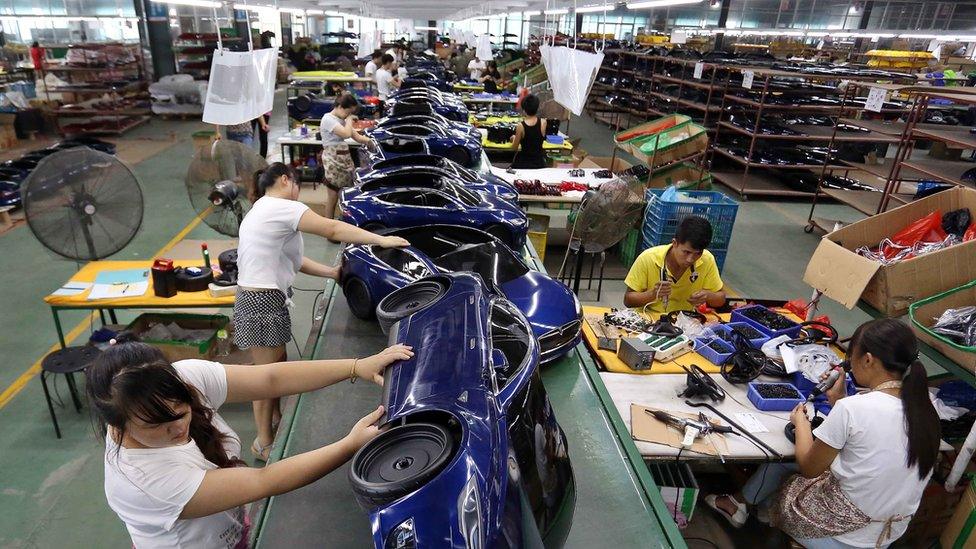 Chinese workers assemble toy cars at a toy factory in Jinjiang, southeast China"s Fujian province on July 1, 2016