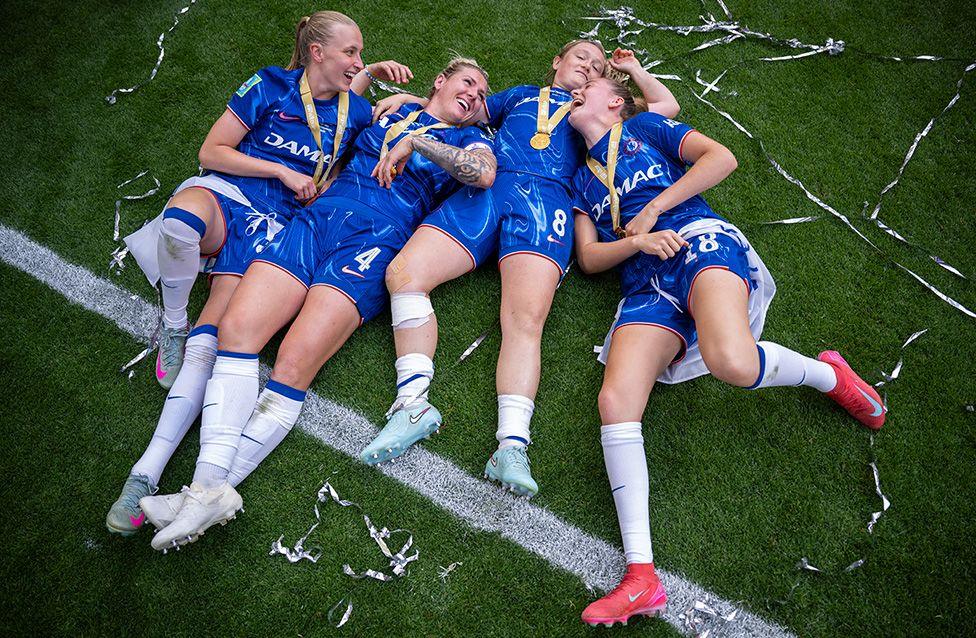 Agnes Beever-Jones, Millie Bright, Erin Cuthbert and Wieke Kaptein of Chelsea celebrate on the Wembley turf after winning the Women's FA Cup final against Manchester United. Photo by Justin Setterfield