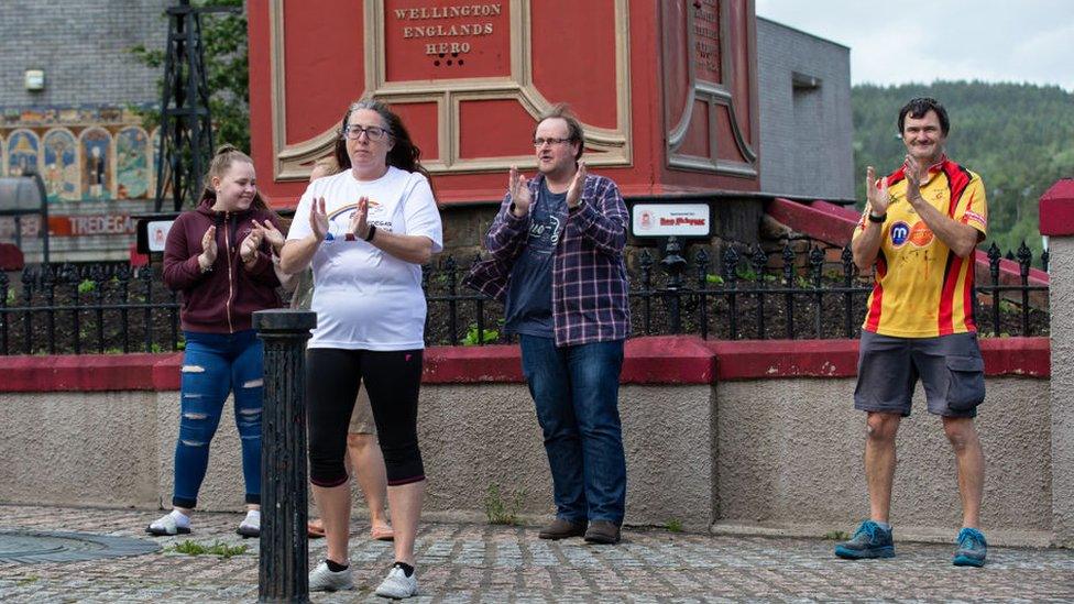 People clap in Tredegar, Wales