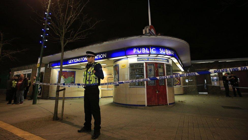 Police officer outside cordoned-off Leytonstone Tube station