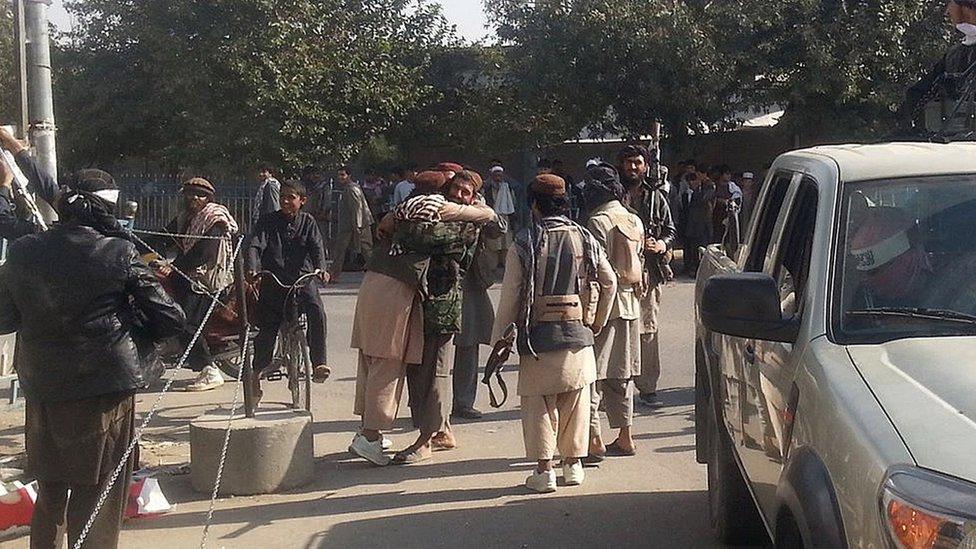 Taliban fighters hug each other in Kunduz