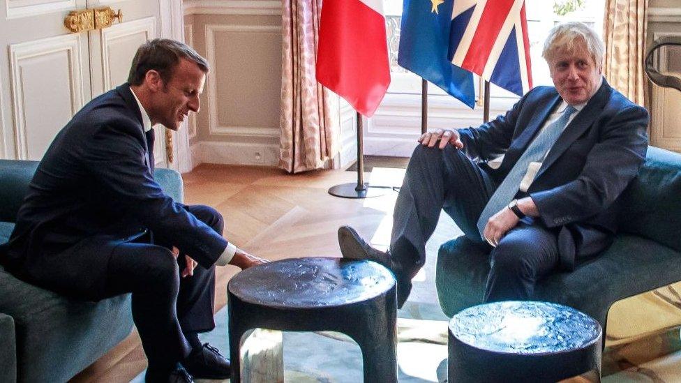 Mr Johnson with his foot on the table at a meeting with Mr Macron last month