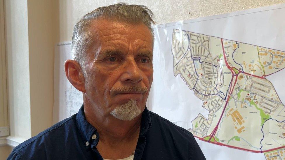 Councillor Richard Brown standing in front of a map of Cheylesmore