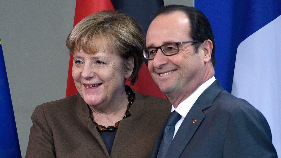 German Chancellor Angela Merkel (left) and French President Francois Hollande (right) shake hands after a press conference