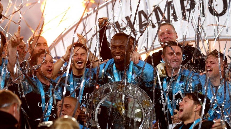 bolt-holds-soccer-aid-trophy