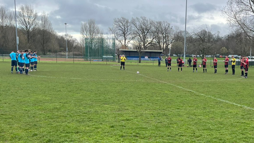 Football players hold round of applause