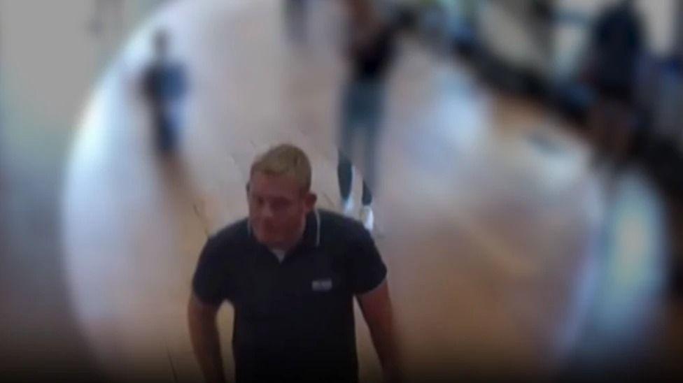 A CCTV image of Michael Jones at Blenheim Palace wearing a blue polo shirt.