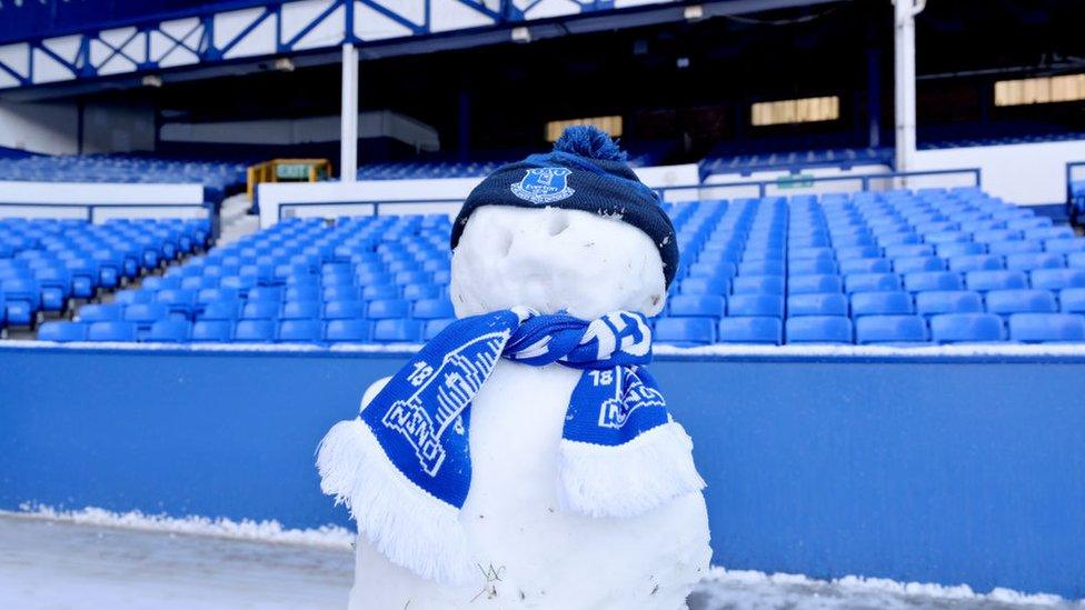 a snowman is draped in an Everton scarf at Goodison Park