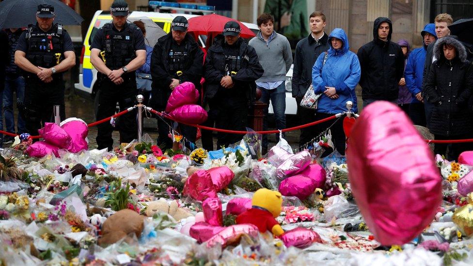 Police officers pause for a minutes' silence in St Ann's Square, Manchester