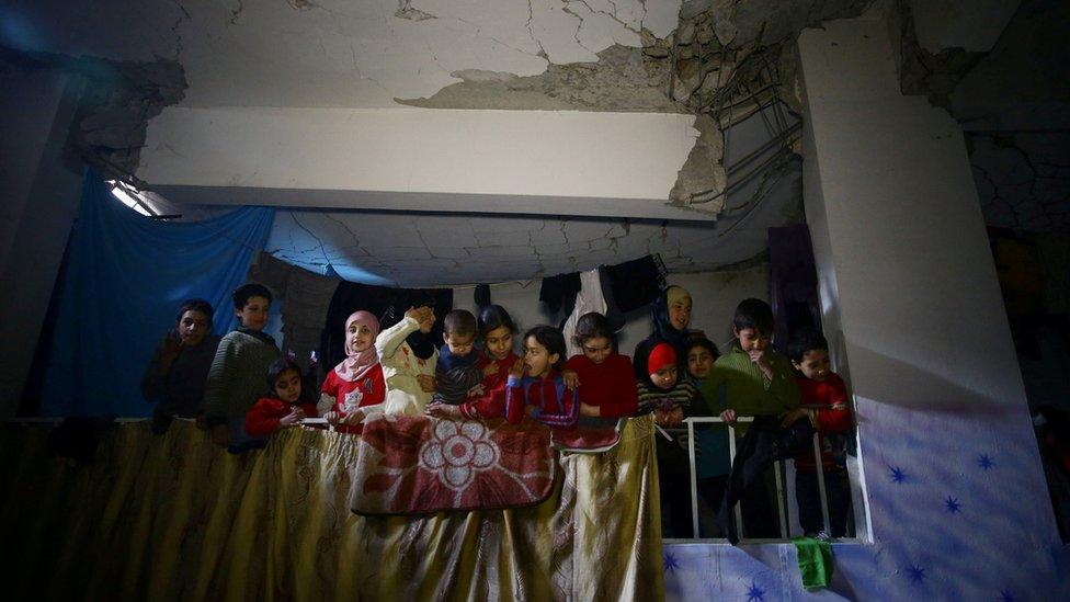 Children are seen in a shelter in the besieged town of Douma, in the rebel-held Eastern Ghouta, outside Damascus, Syria (11 March 2018)