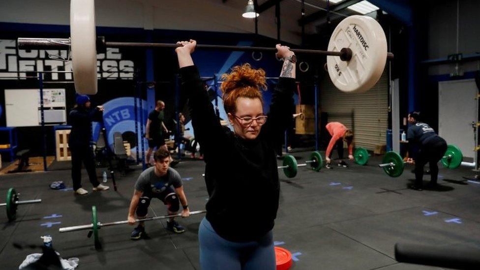 People attend a strength and conditioning class at Ultimate Fitness Gym in Wallsend, north-east England