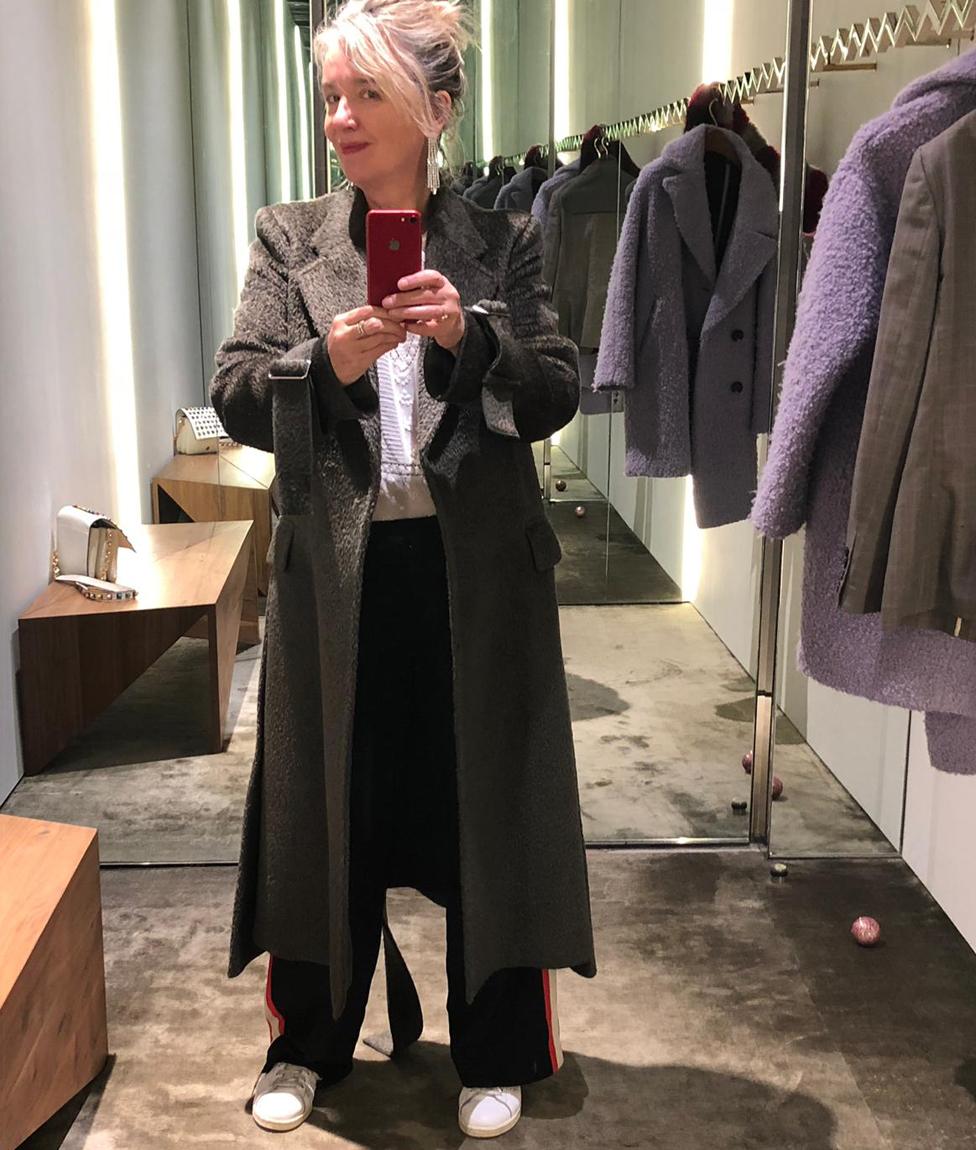 Wendy takes a selfie in a long coat