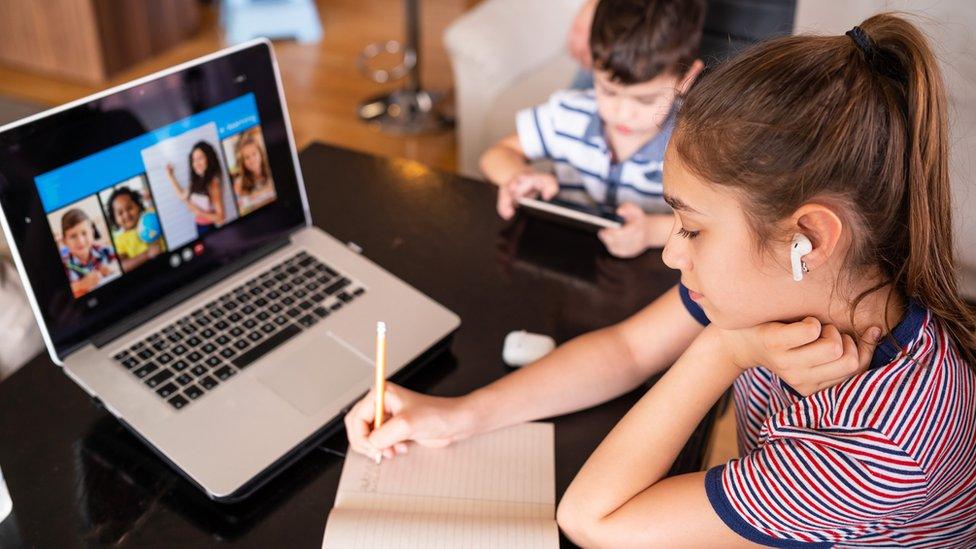 girl-on-computer-and-boy-on-phone.