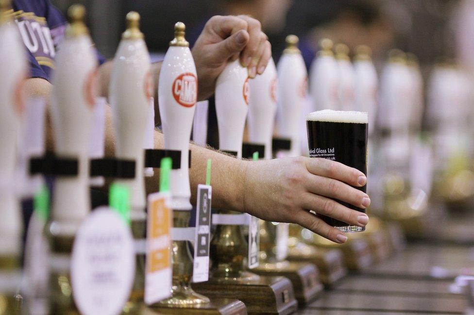 Bartender serves ale at the CAMRA beer festival