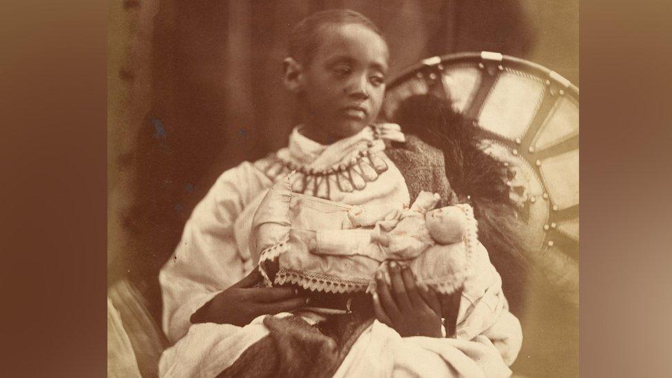 Prince Alemayehu holding a doll