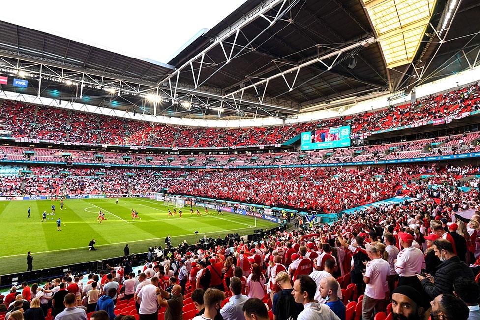 Fans watch the warm ups ahead of the UEFA EURO 2020 semi-final football match between England and Denmark at Wembley Stadium