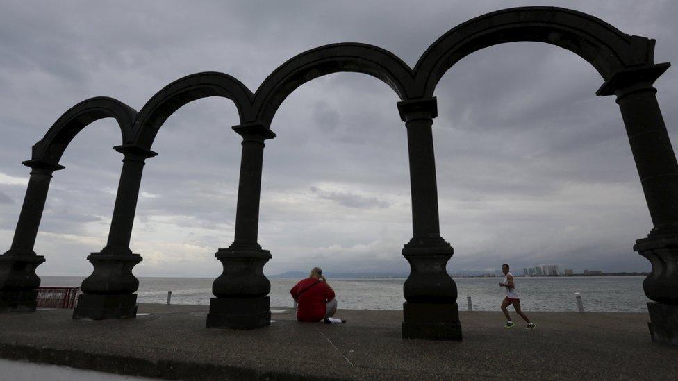 A man runs along the beach in Puerto Vallarta