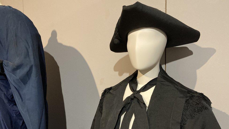 Robes and hat on display at the exhibition