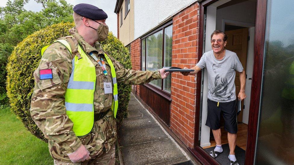 Ministry of Defence undated handout photo of Gunner Emery (1RHA) hands a Bolton resident a COVID19 testing kit. Across the UK, members of the Armed Forces have been working to support the rollout of the coronavirus vaccine programme, with new deployments planned in Scotland and North West England