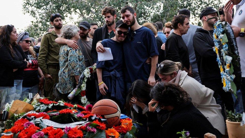 Friends of family of Alon Lulu Shamriz mourn him at his funeral in Shefayim, Israel, after he was mistakenly killed by Israeli forces in Gaza (17 December 2023)