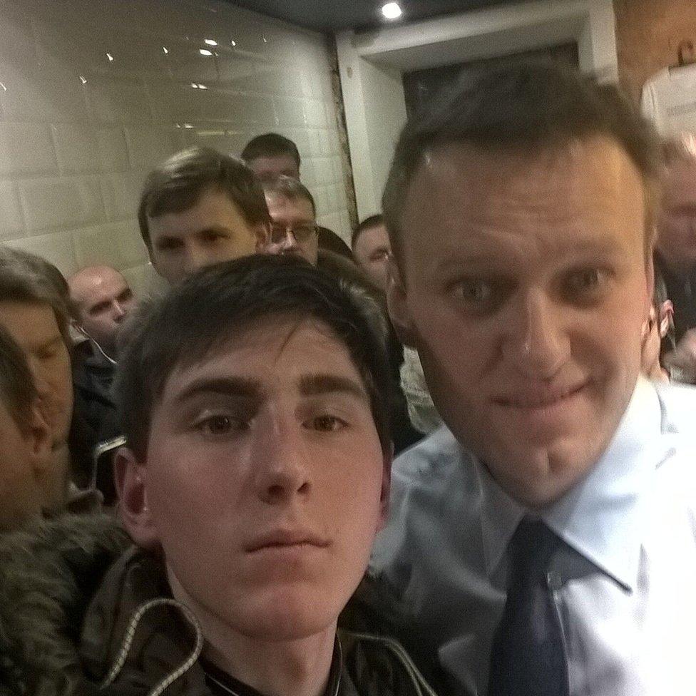 Young Russian protester Pavel Leshev takes a selfie with opposition leader Alexei Navalny