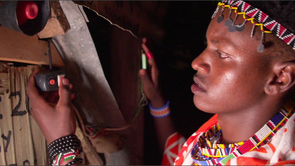 Richard Turere looking at his lion lights