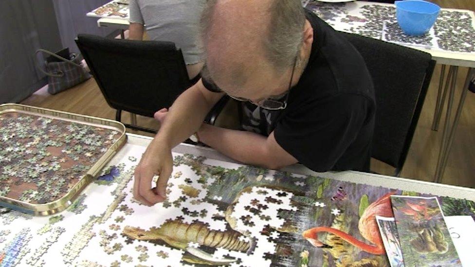 Volunteer putting puzzle together