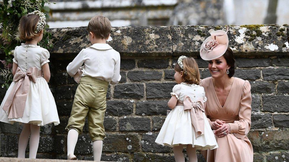 Duchess of Cambridge stands with her daughter Princess Charlotte, a bridesmaid