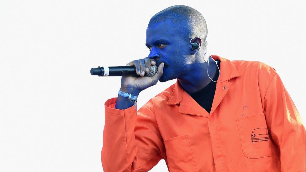 Ameer Vann performing on stage with Brockhampton