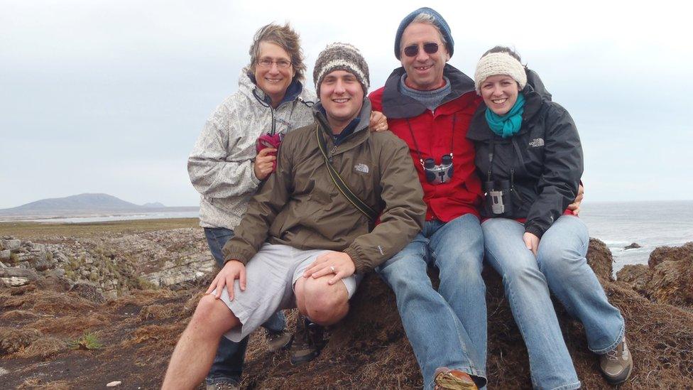 Sam with his family on the island