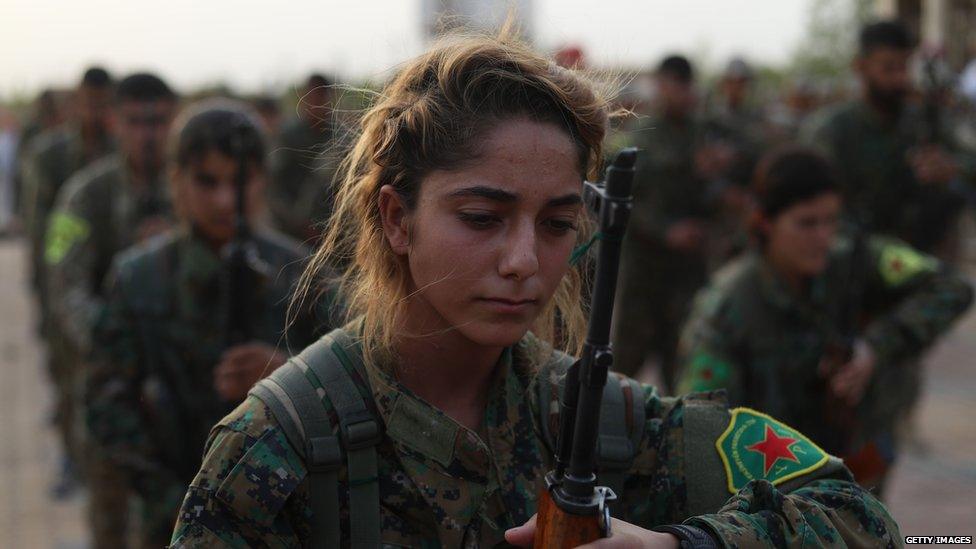 Fighters from the Syrian Democratic Forces attend a funeral of fellow fighters