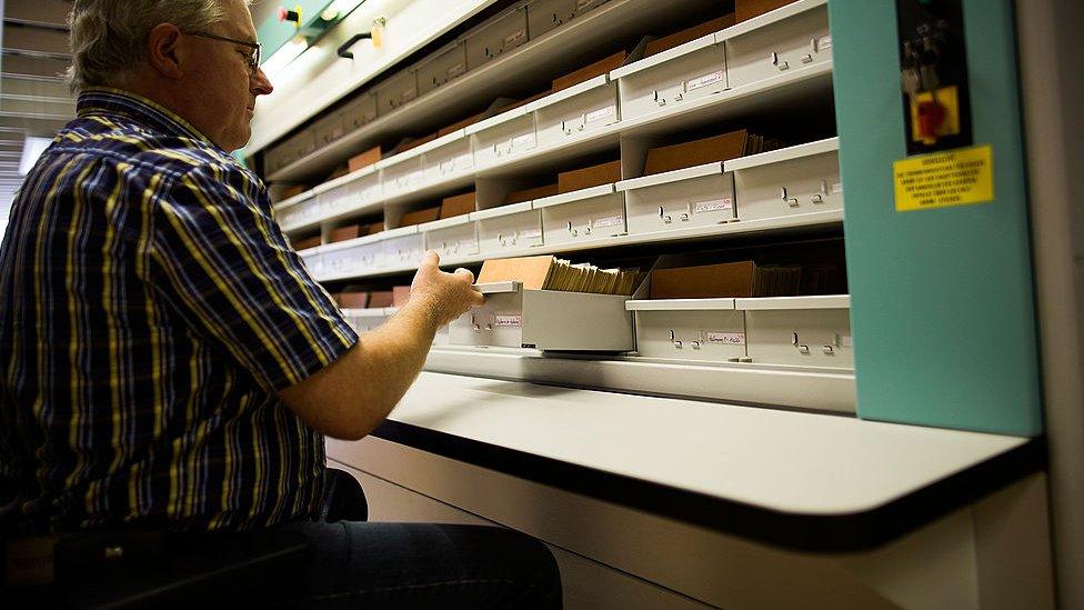 A man checks the documents at the archives of the former East German secret police, known as the Stasi, on September 17, 2014 in Berlin, Germany.