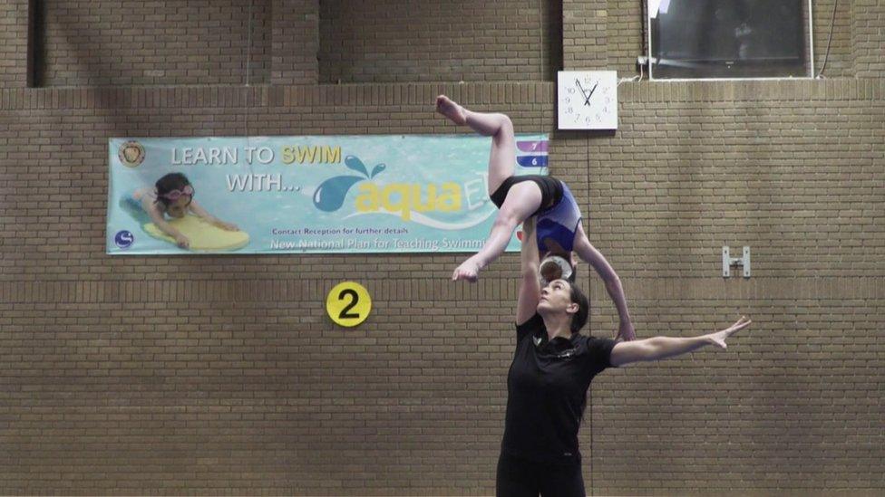 Tegan and gymnastics coach, practising a lift