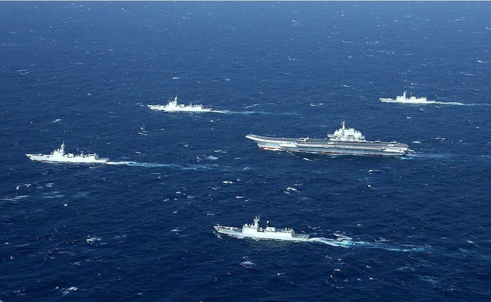 This aerial photo taken on 2 January 2017 shows a Chinese navy formation, including the aircraft carrier Liaoning (C), during military drills in the South China Sea.