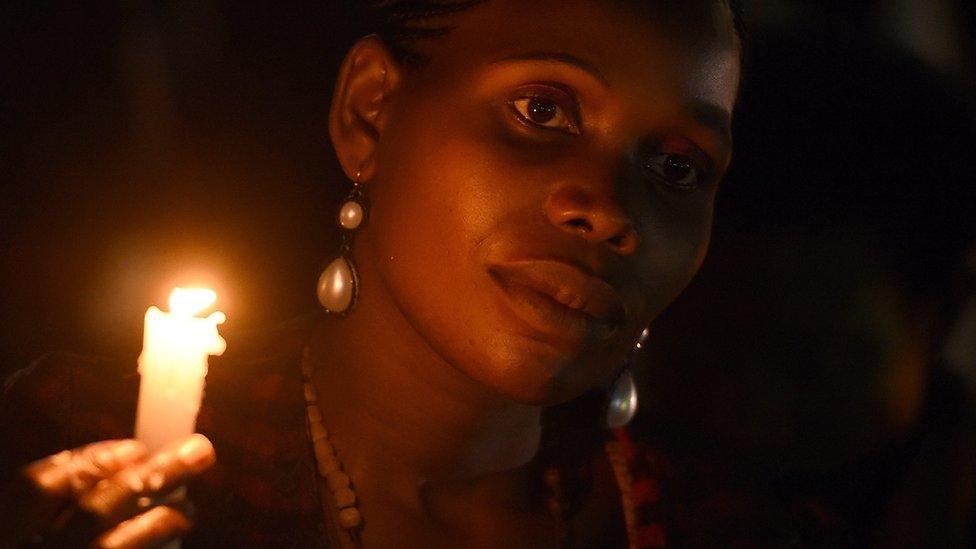 A woman holds a candle as she awaits the arrival of Pope Francis at the martyrs' shrine in Munyonyo, near Kampala, Uganda, 27 November 2015