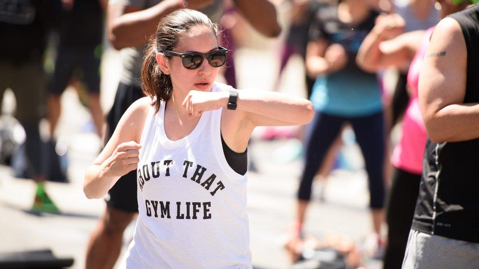 A woman looks at her FitBit